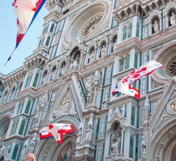 Duomo of Florence with flags thrown in the air in front of it