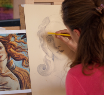 the image demonstrates the young woman taking part in an art course, drawing from Botticelli's Birth of Venus